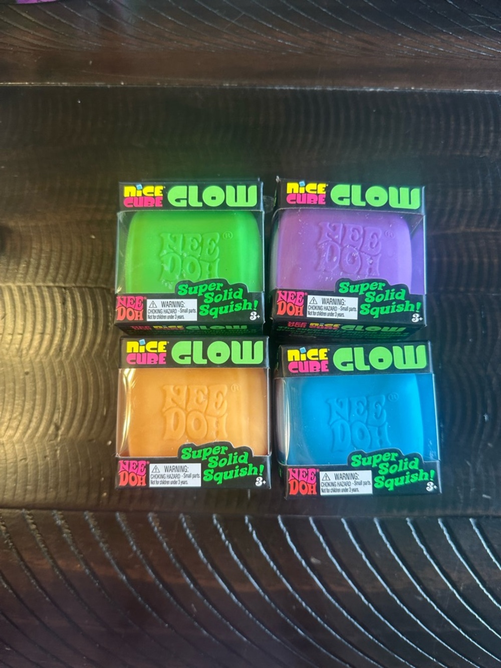 NeeDoh Glow Nice Cube Super Solid Squish Set - Green, Purple, Orange, Blue
